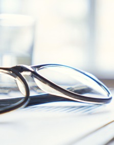 A pair of glasses on top of paperwork