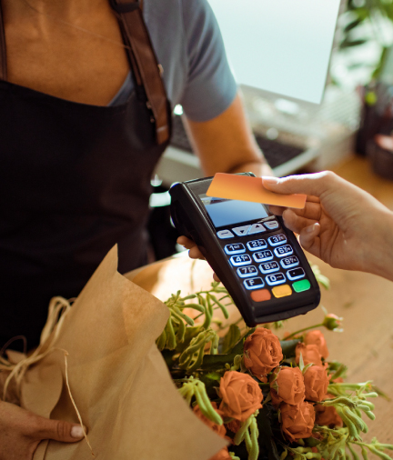 woman buying flowers paying with credit card