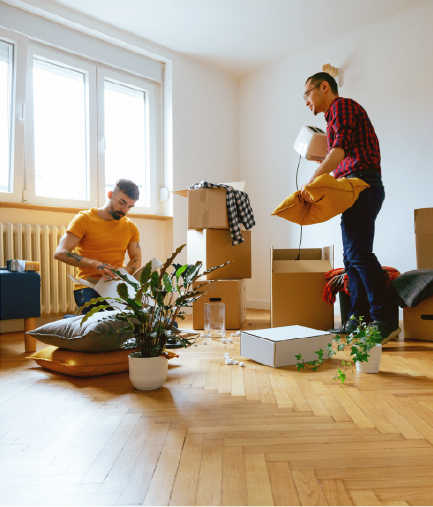 two men unpacking boxes in their new home