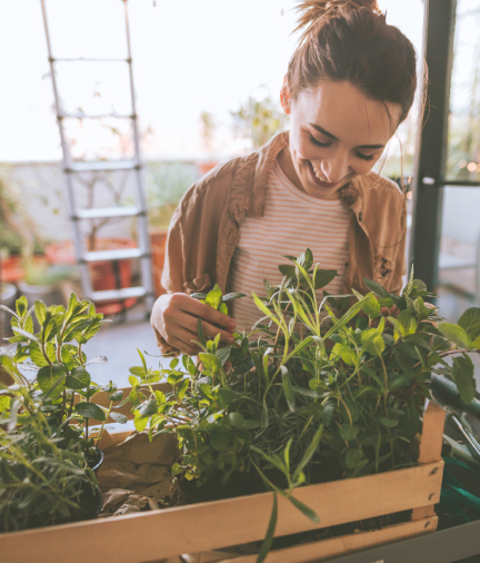 woman smiling looking at plants
