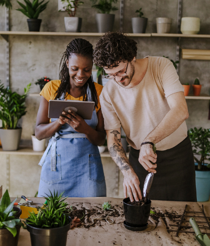 man and woman planting plants indoors