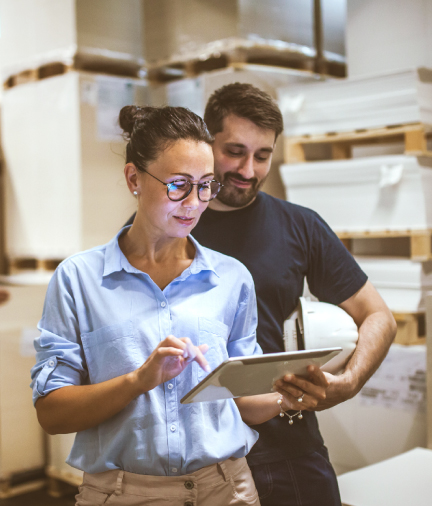 man and woman looking at tablet smiling